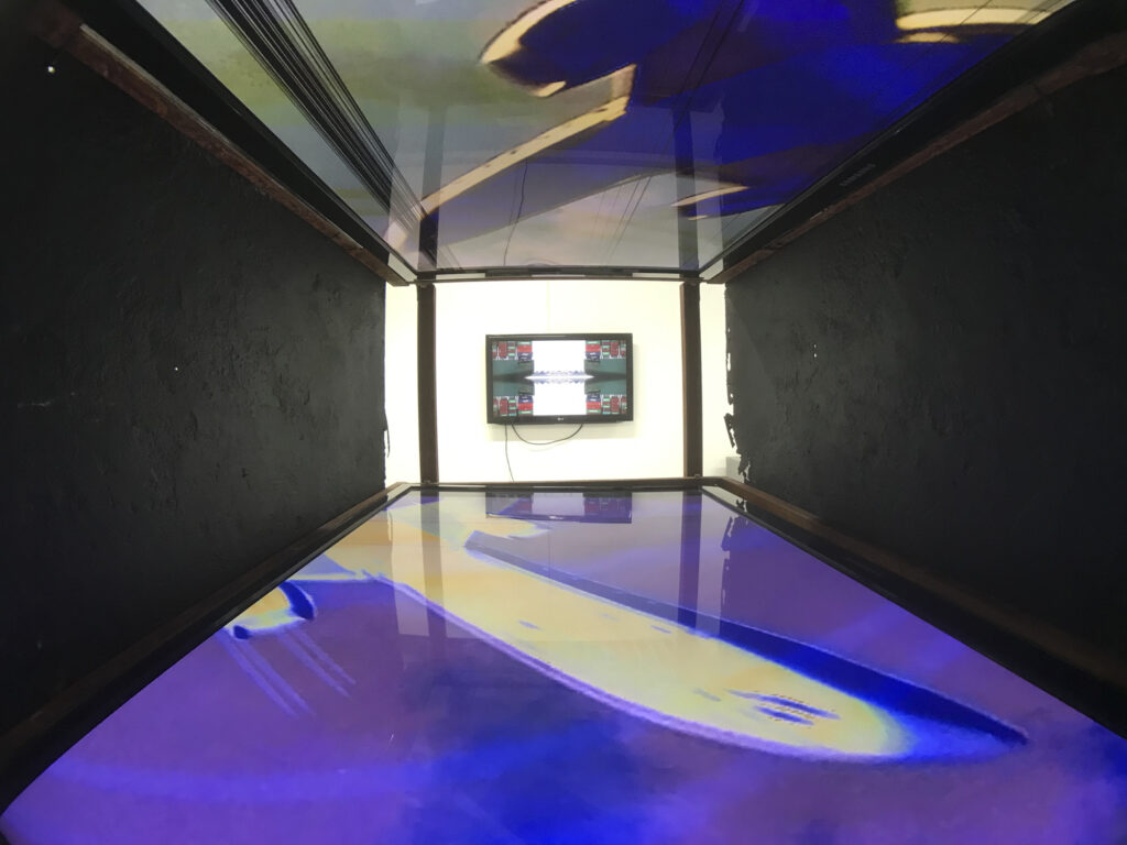 Art installation, two damaged tv screens facing each other.