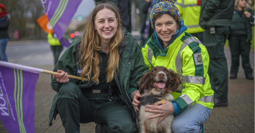 Striking ambulance workers with their dog
